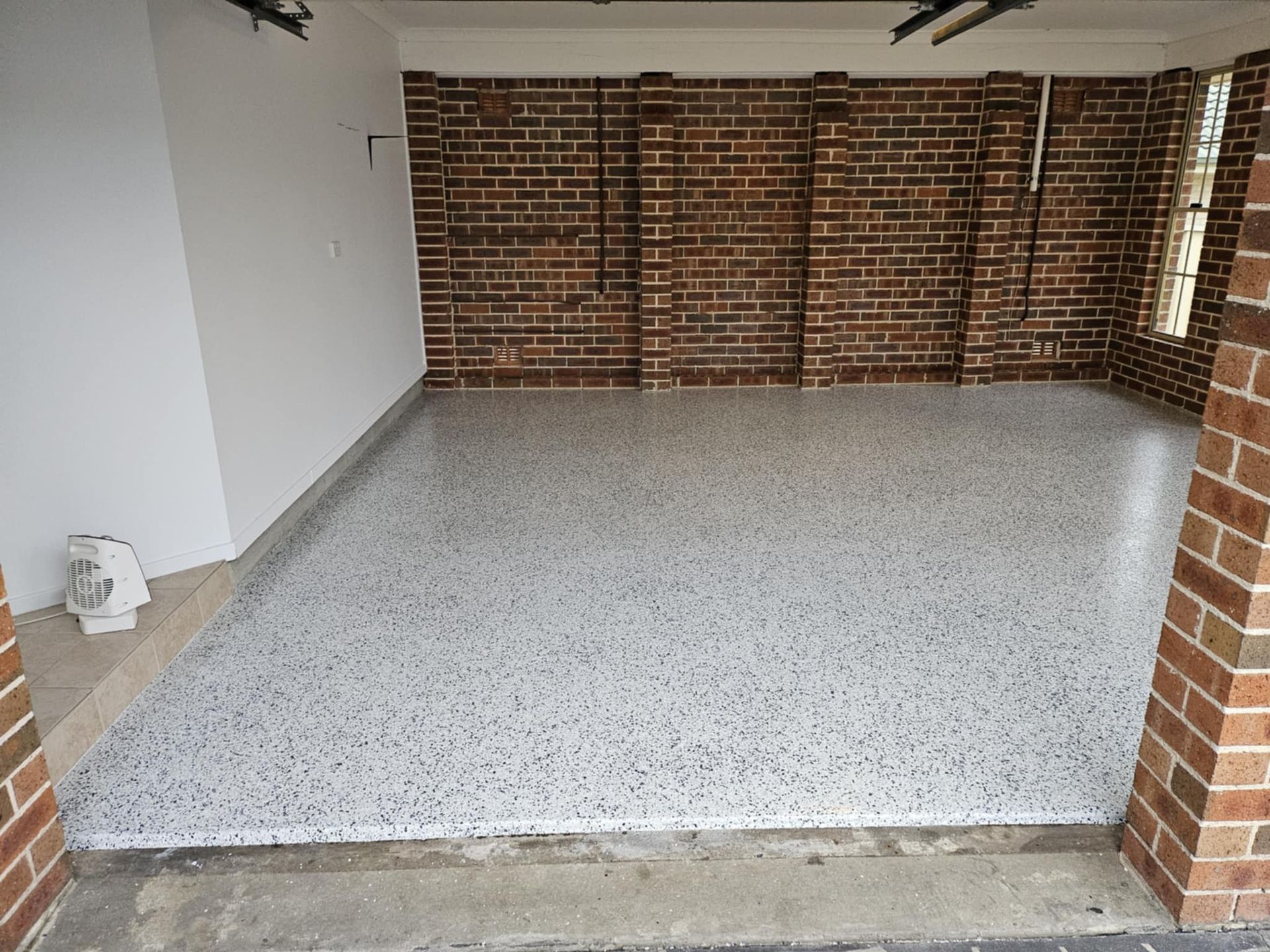 A garage with a brick wall and a white floor — That Painter Guy In South Nowra, NSW