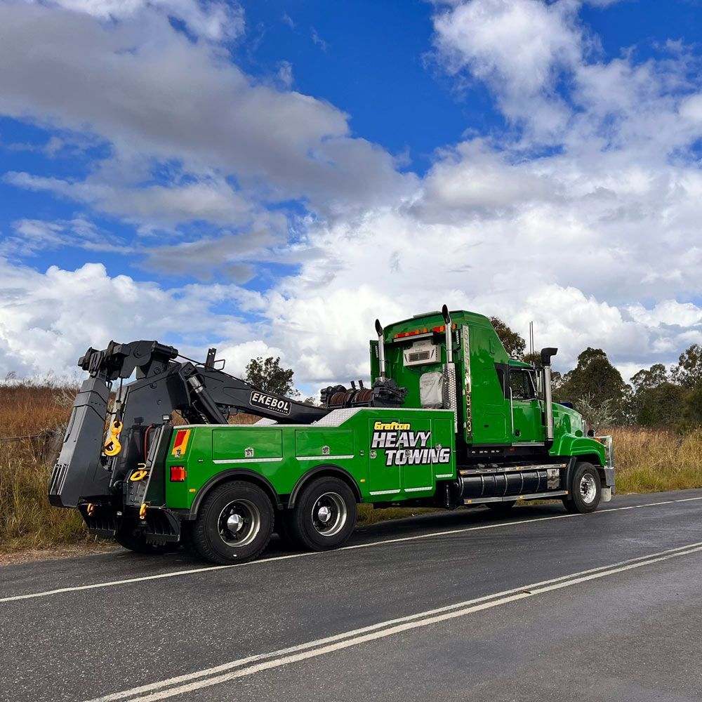A Green Towing Truck Parked on Parked on The Highway — Grafton Heavy Towing In Grafton NSW