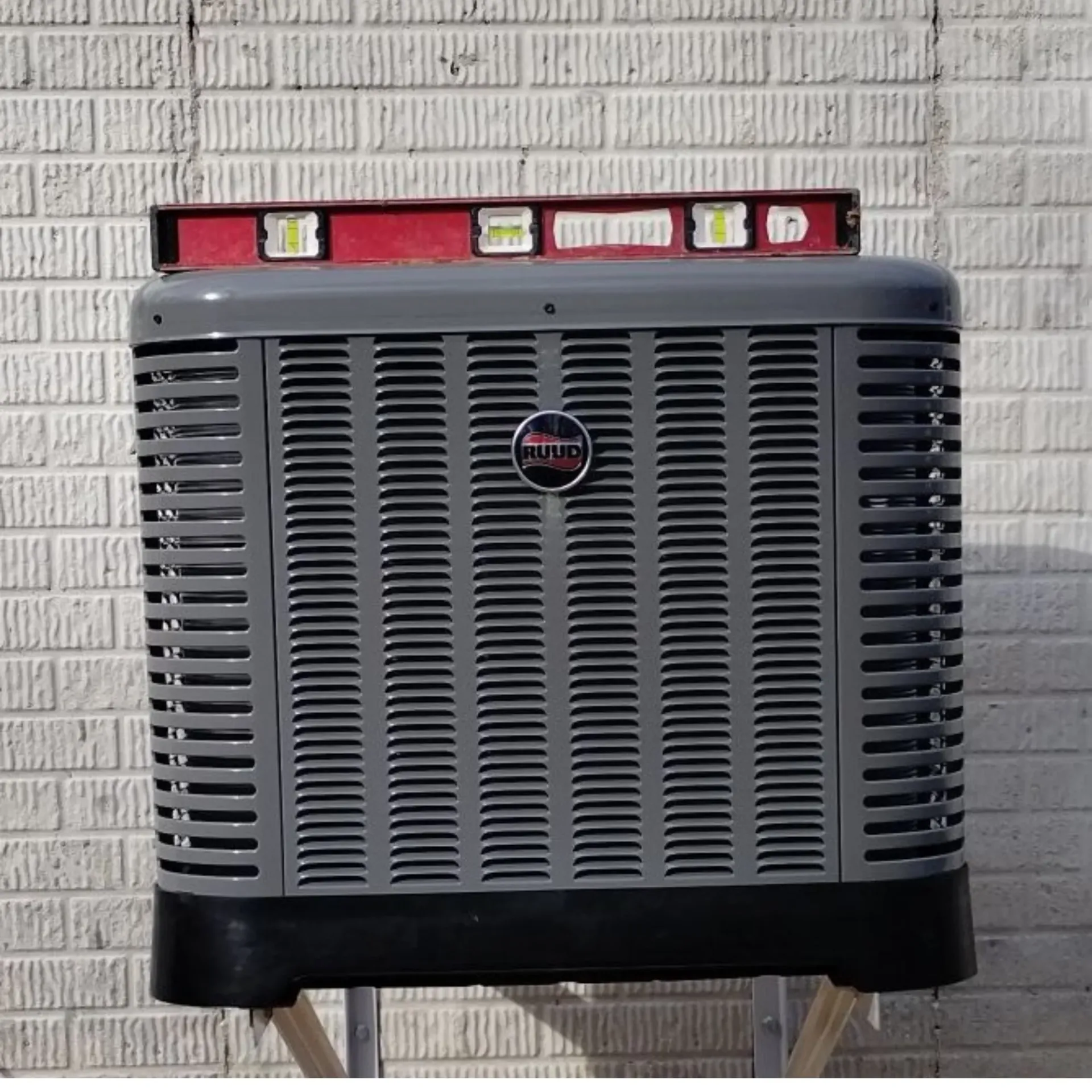 Kingdom Air LLC - An air conditioner with a level on top of it