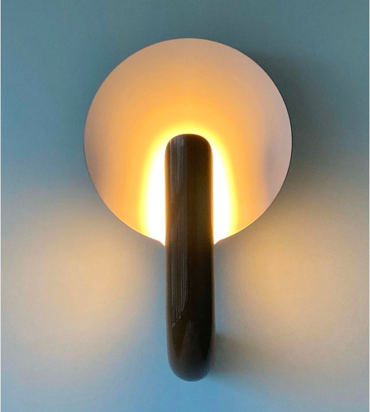 A light is shining on a blue wall.