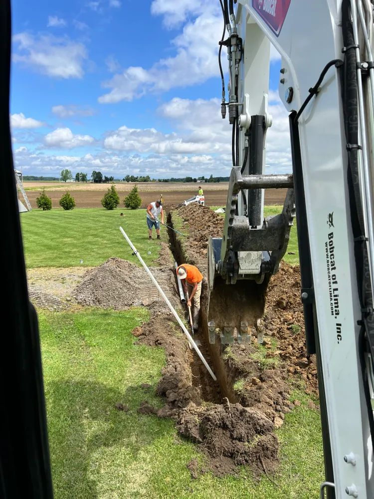 A man is using a shovel to dig a hole in the ground.