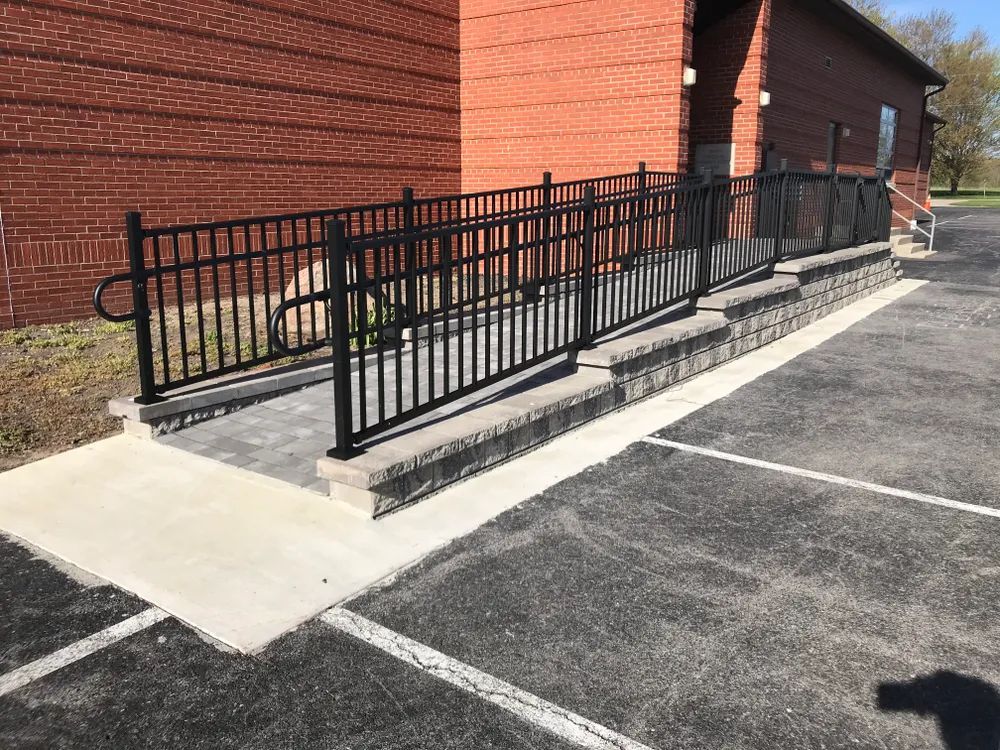 A ramp in a parking lot next to a brick building.