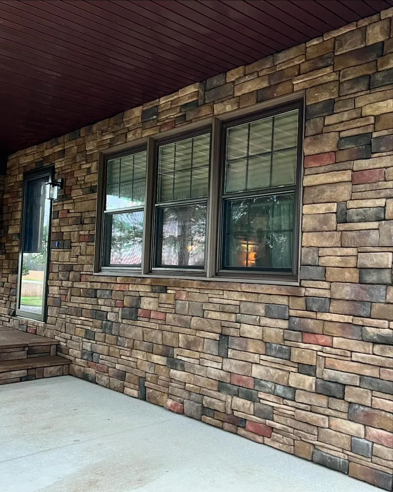 A brick wall with a lot of windows on it.