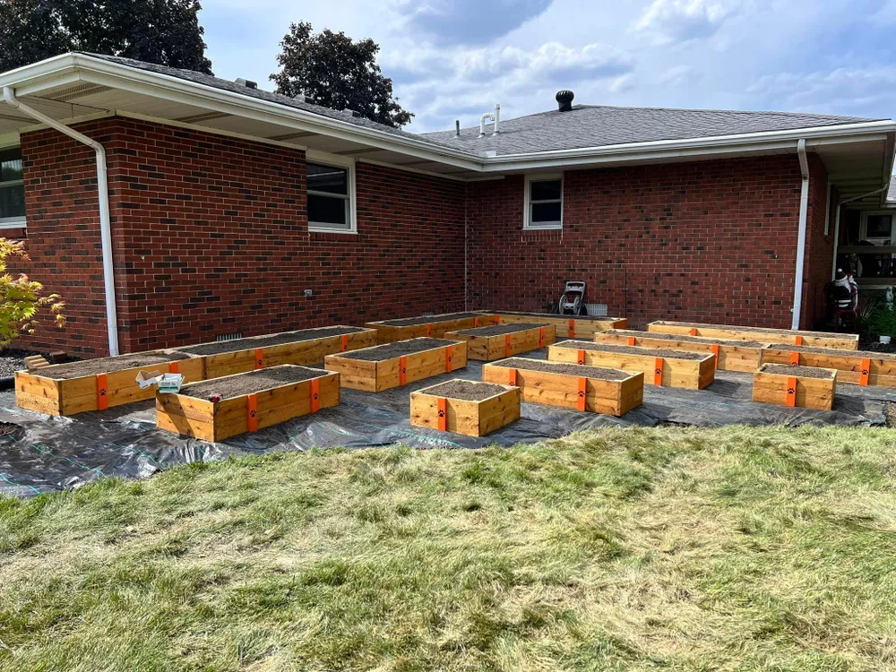 A brick house with a lot of wooden boxes in front of it.