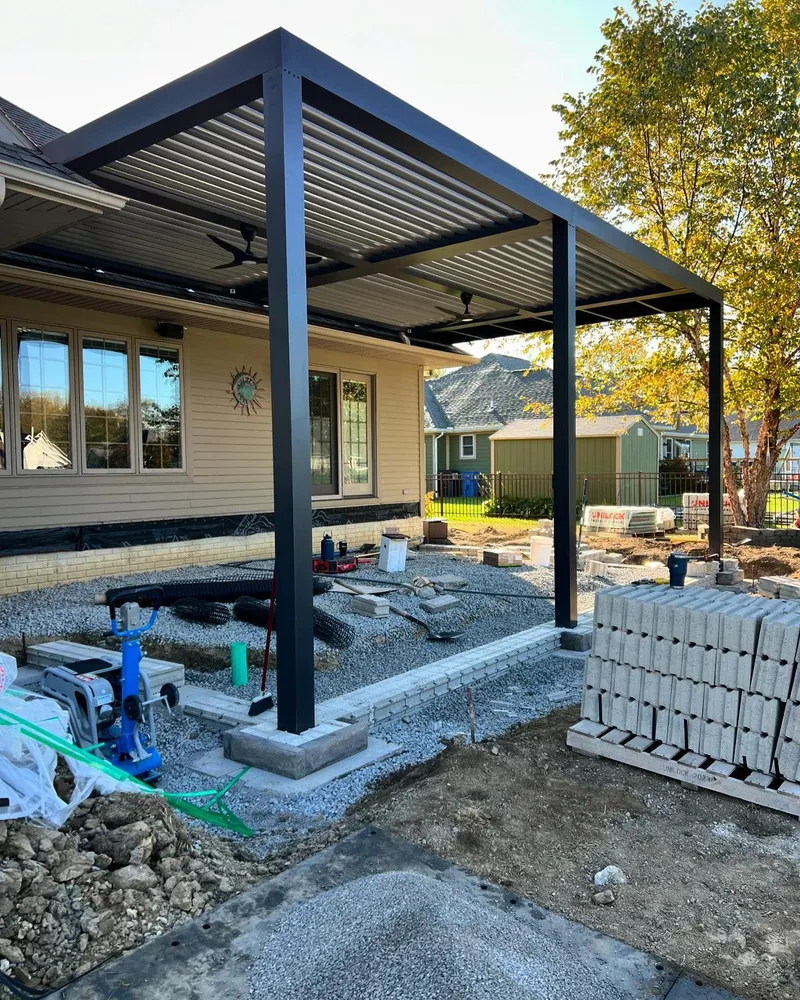 A pergola is being built in front of a house.