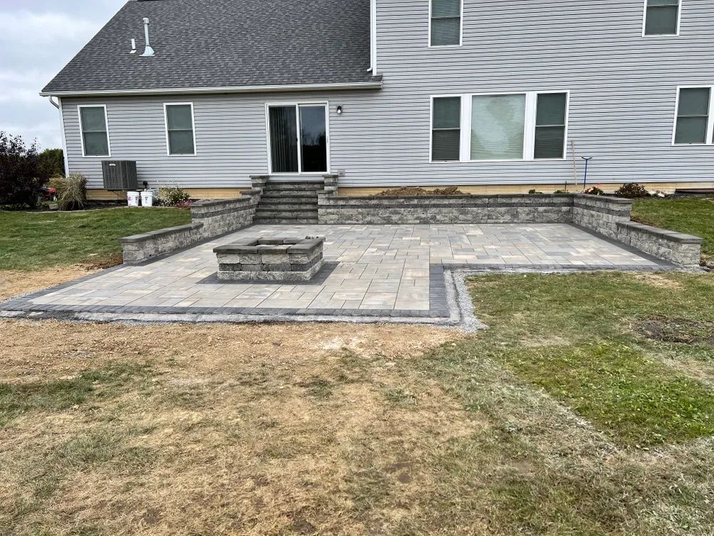 There is a fire pit in the backyard of a house.