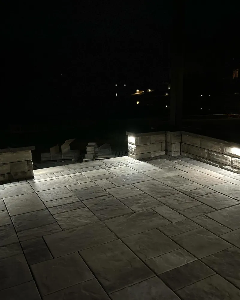 A patio with lights on it at night.