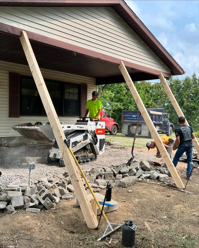 A group of men are working on a house.