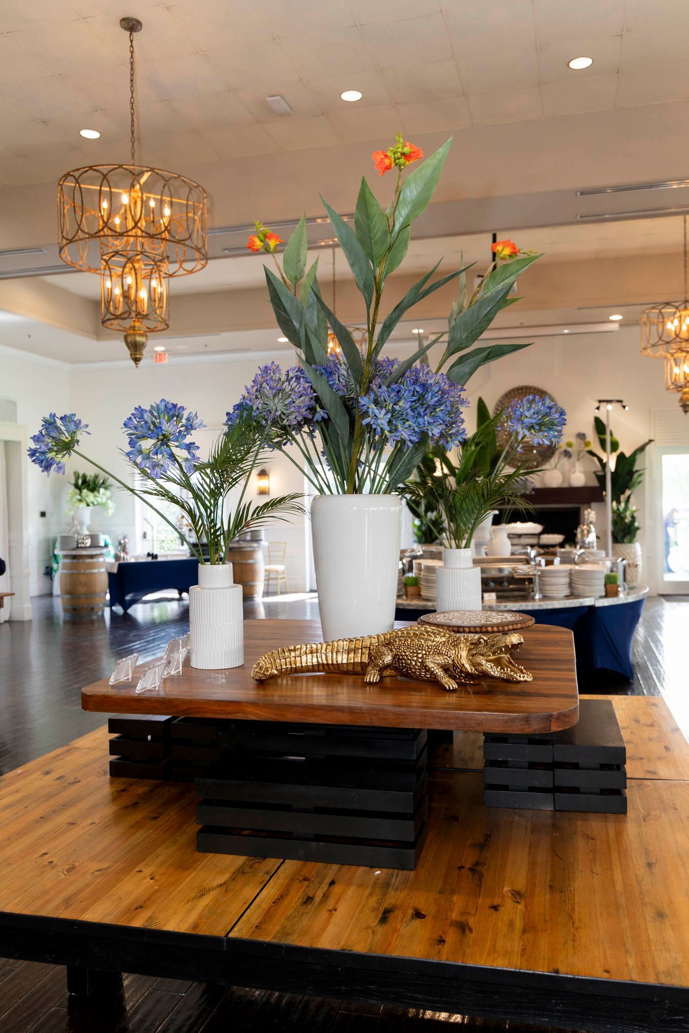 A table with vases of flowers on it in a room.