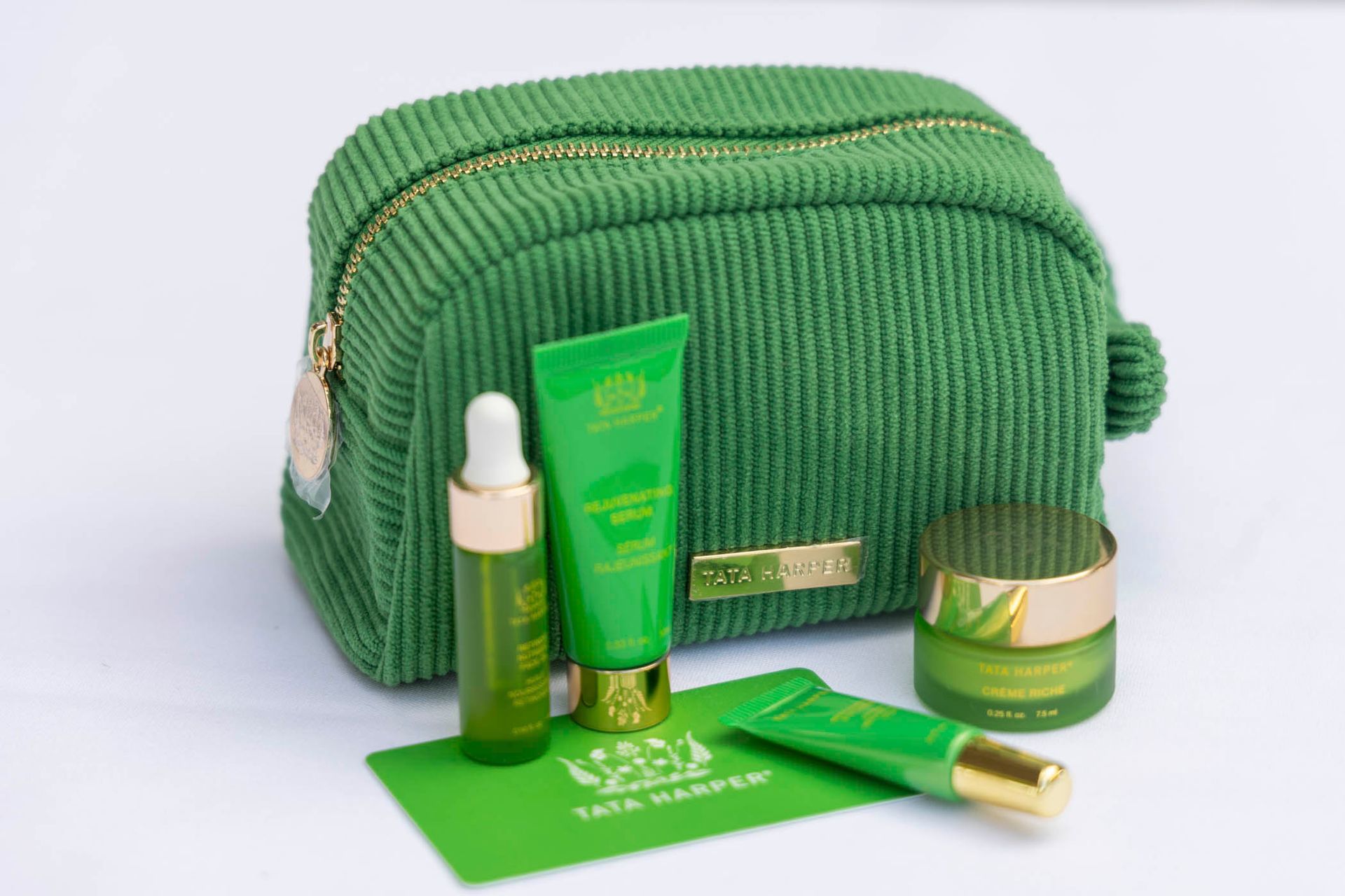 A green cosmetic bag filled with a variety of cosmetics.