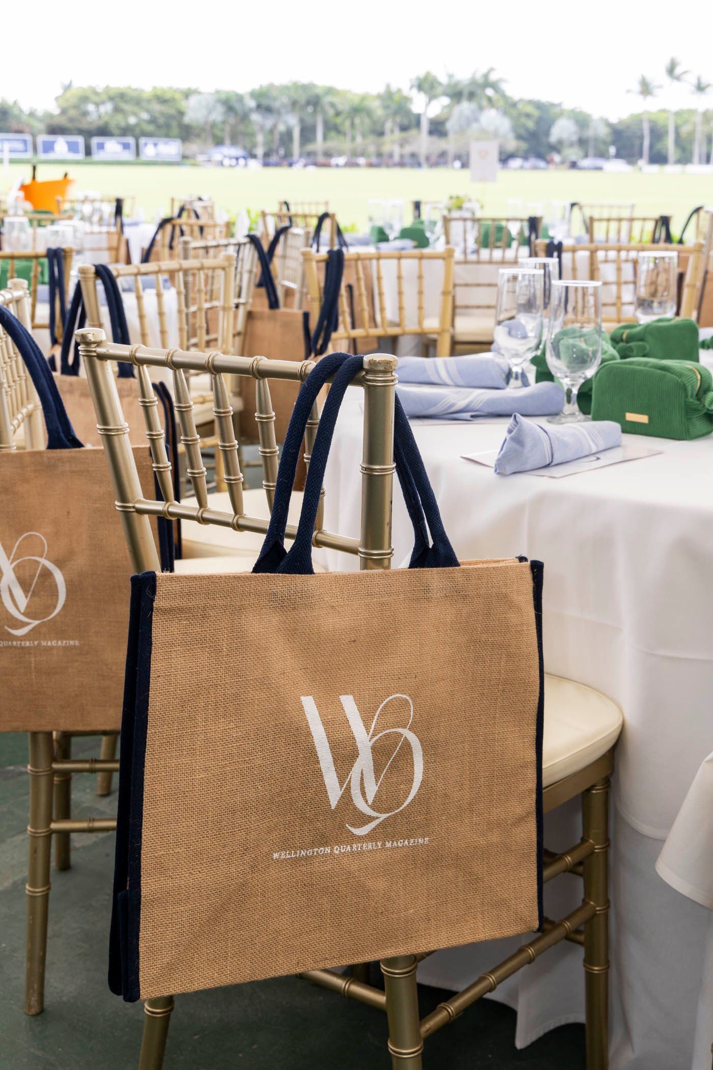 A bag with the letter w on it is sitting on a chair.