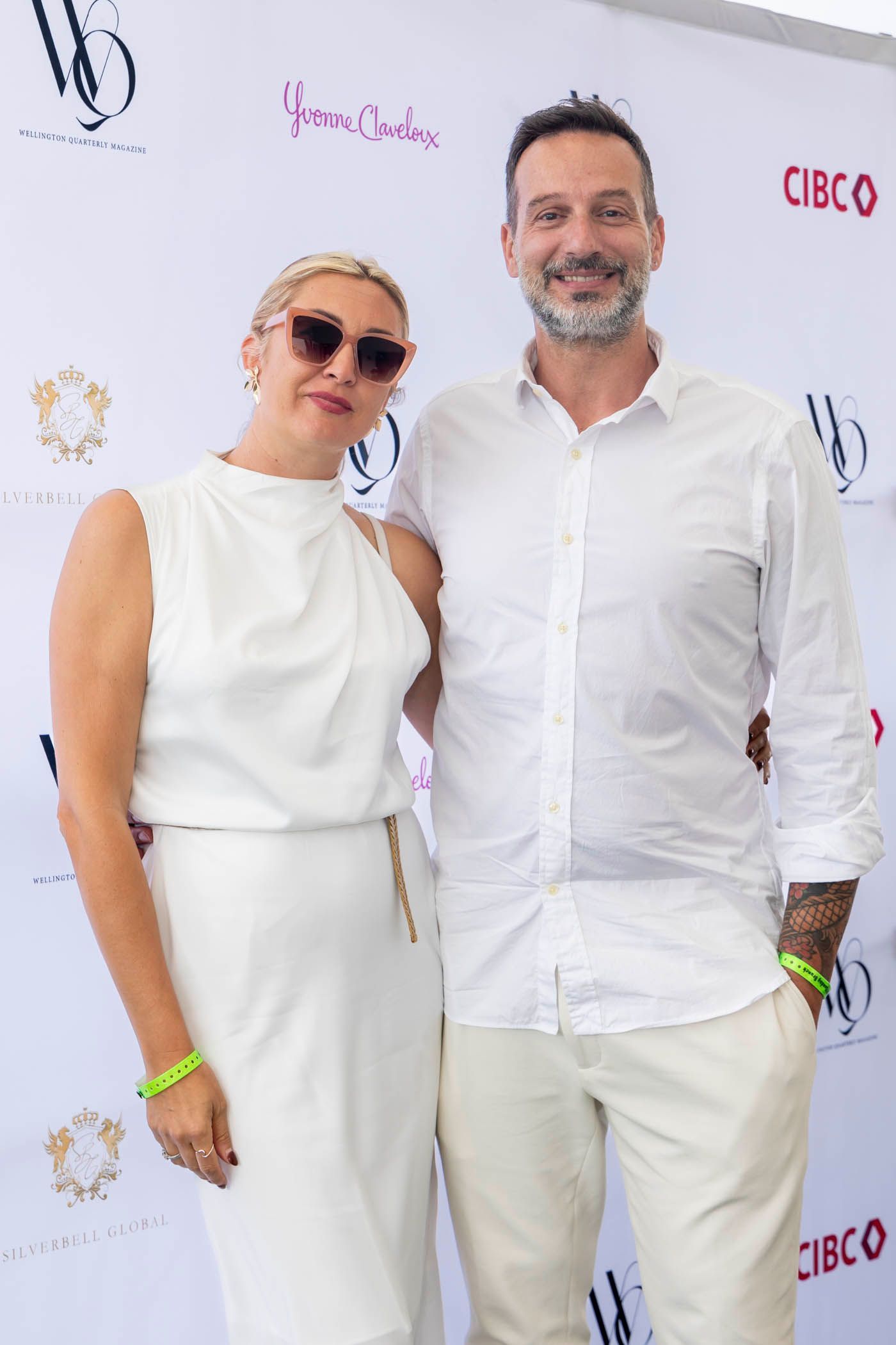 A man and a woman are posing for a picture in front of a wall that says cisco