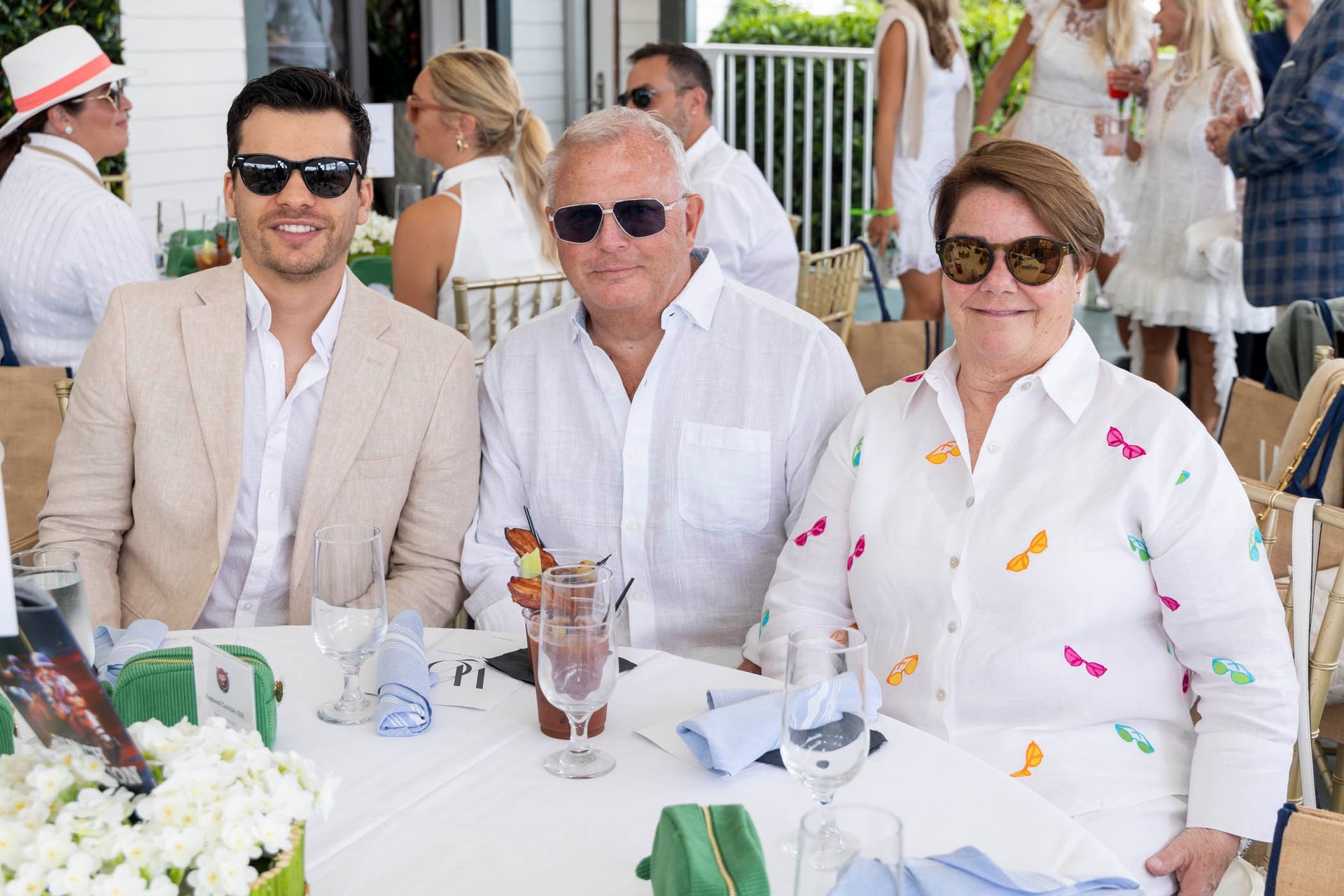 A group of people are sitting at a table with glasses of wine.