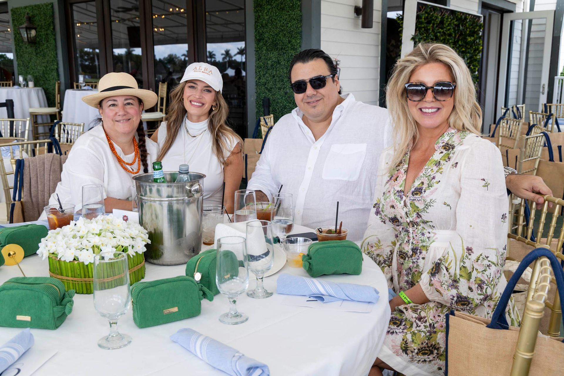 A group of people are sitting at a table with glasses of wine.