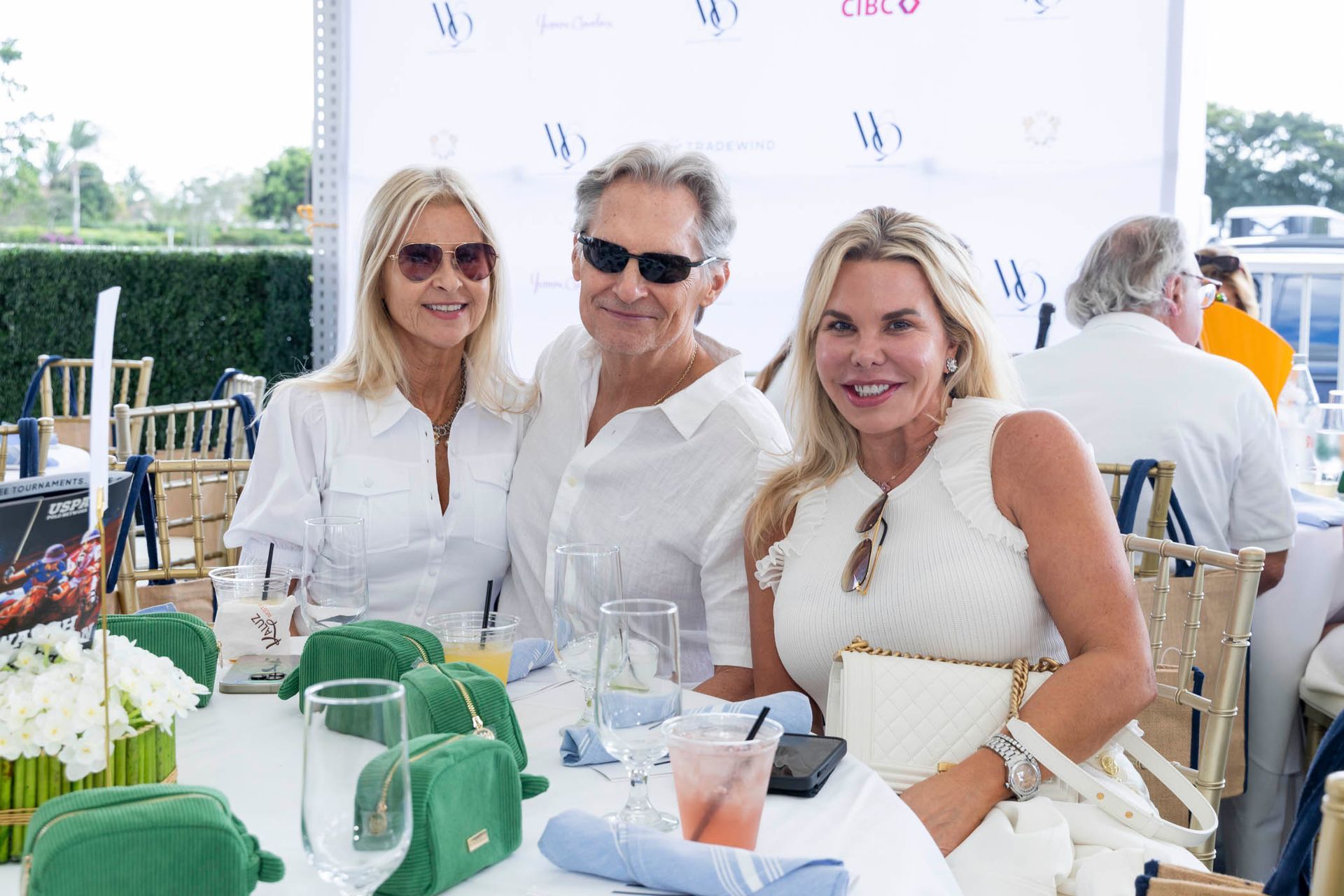 A group of people are sitting at a table with glasses of wine.