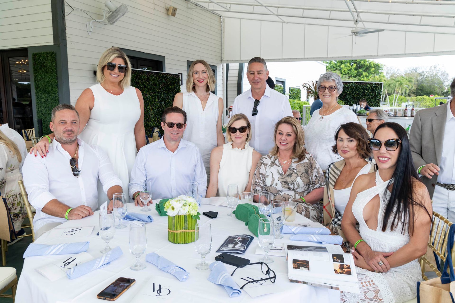 A group of people are posing for a picture at a table.