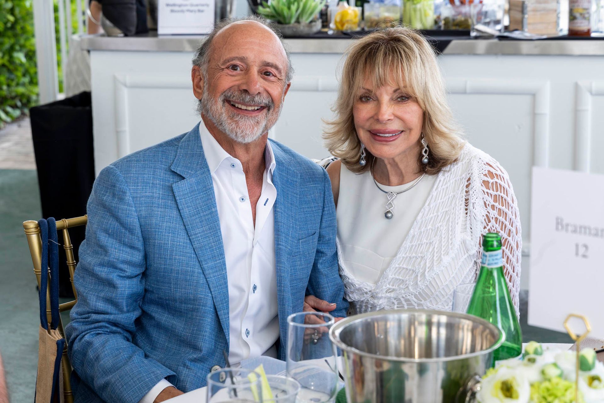 A man and a woman are sitting at a table.