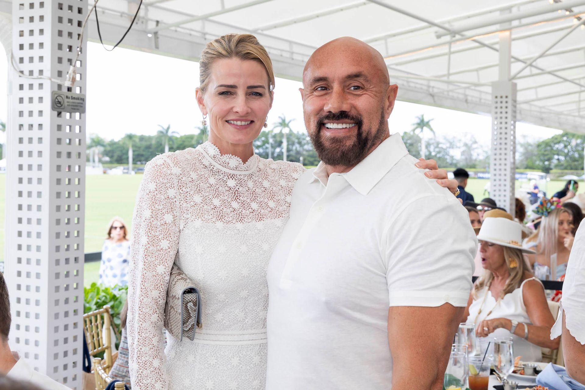 A man and a woman are posing for a picture at a party.
