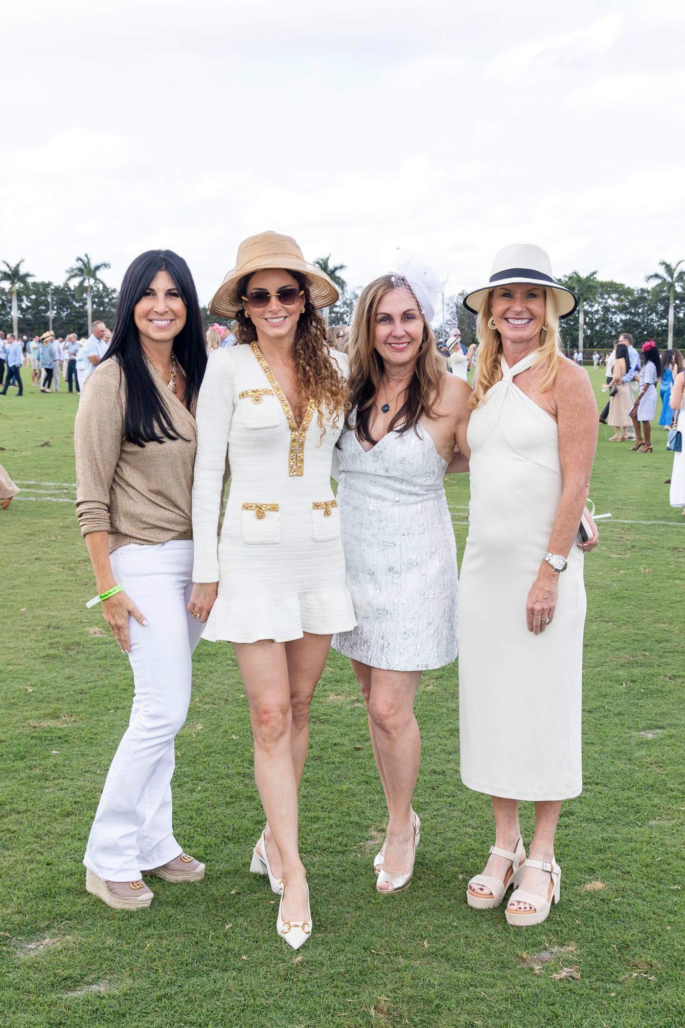 A group of women are posing for a picture in a field.