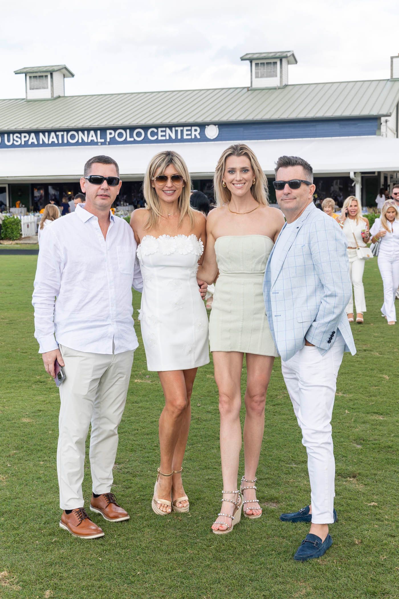 A group of people are posing for a picture in front of a building.