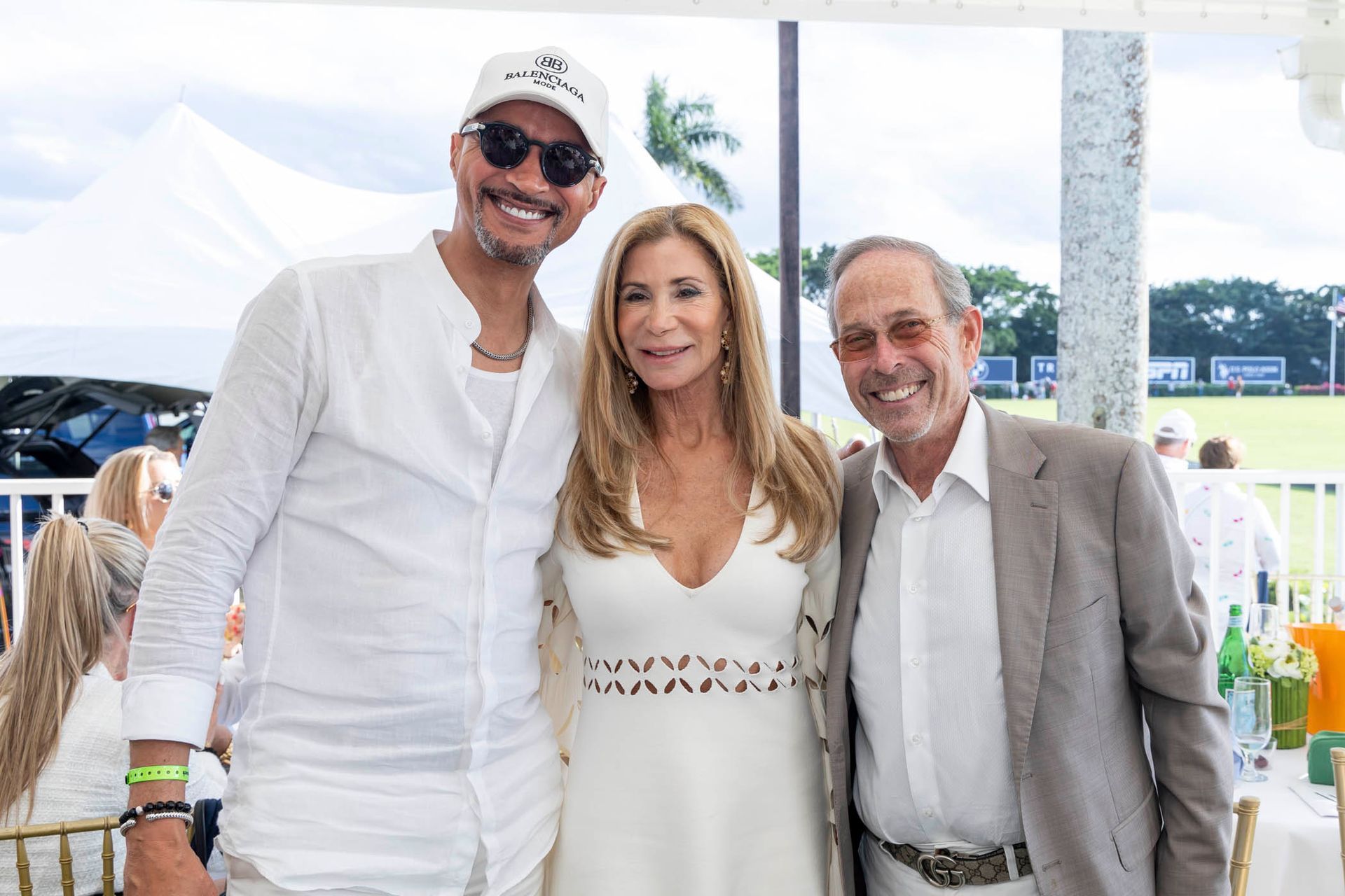 A man , a woman and a man in a suit are posing for a picture.