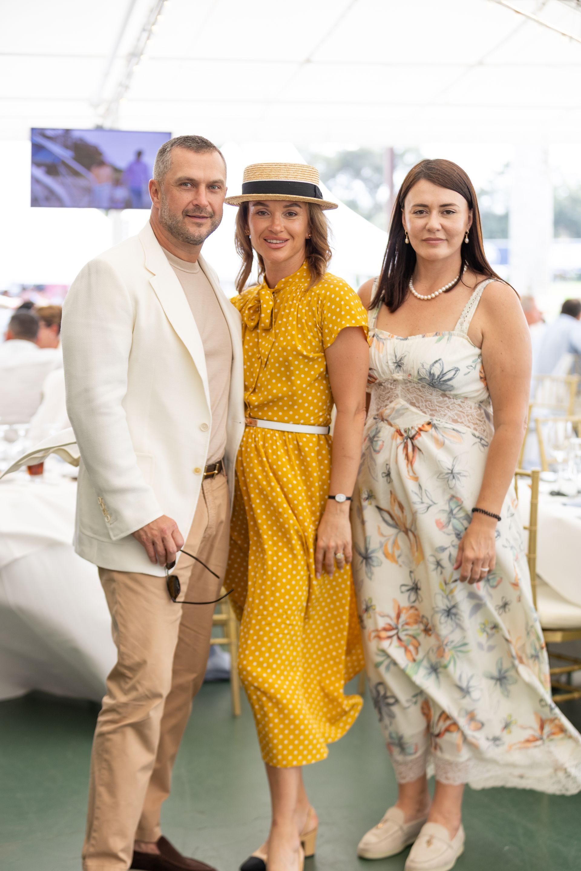 Three people pose outdoors
