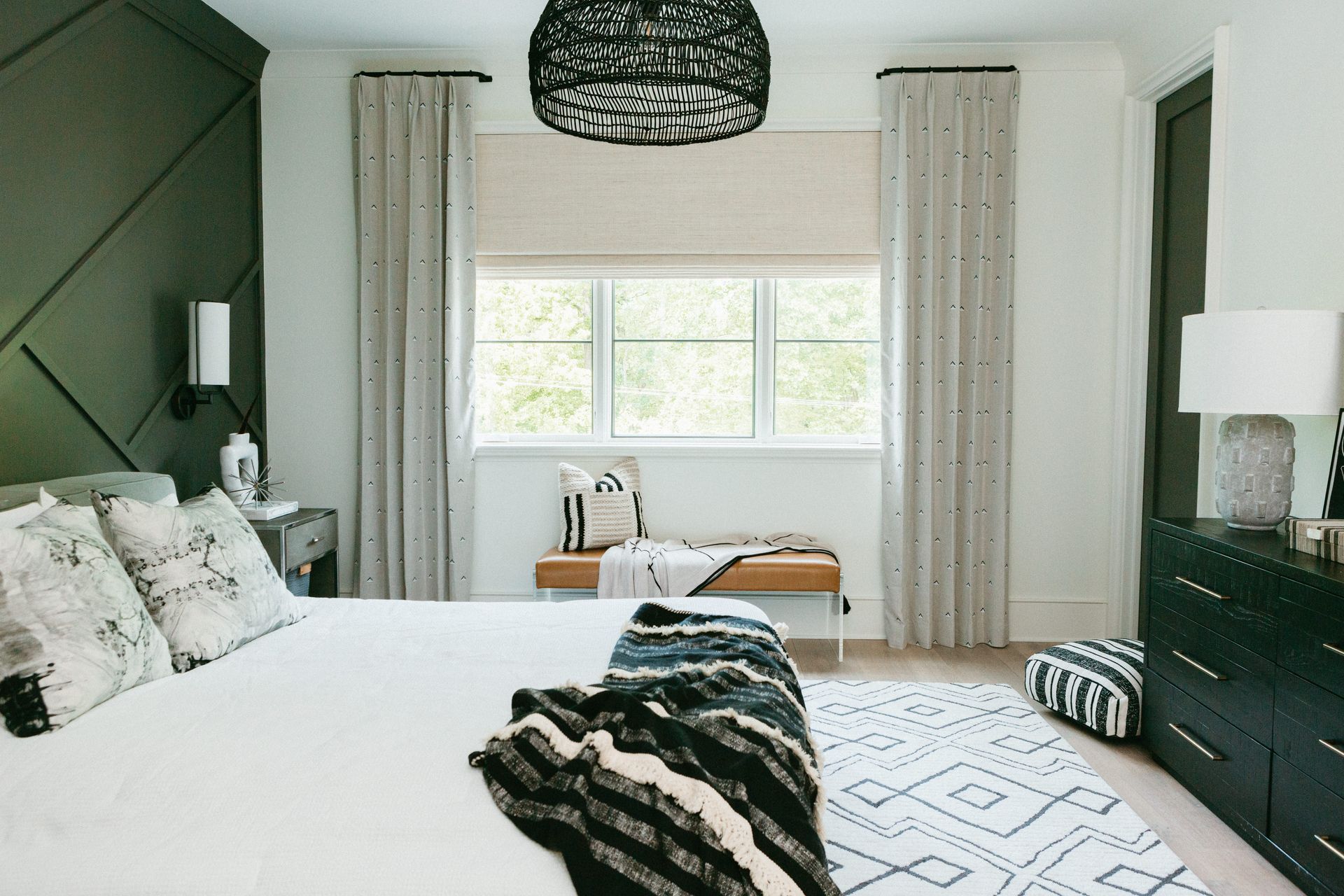 A Bedroom With A Bed, Dresser, Rug And Window