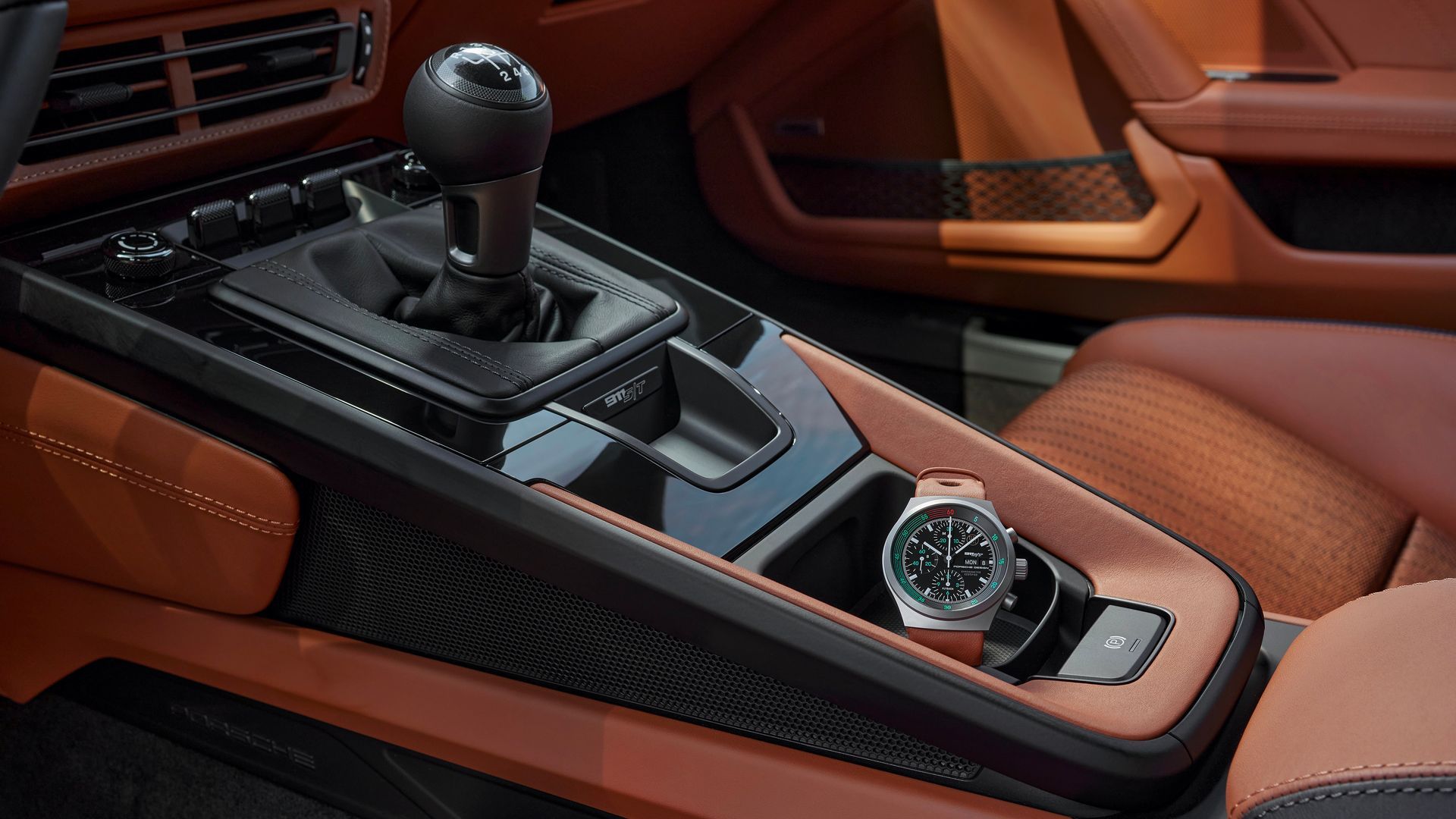A Watch Is Sitting In The Center Console Of A Car