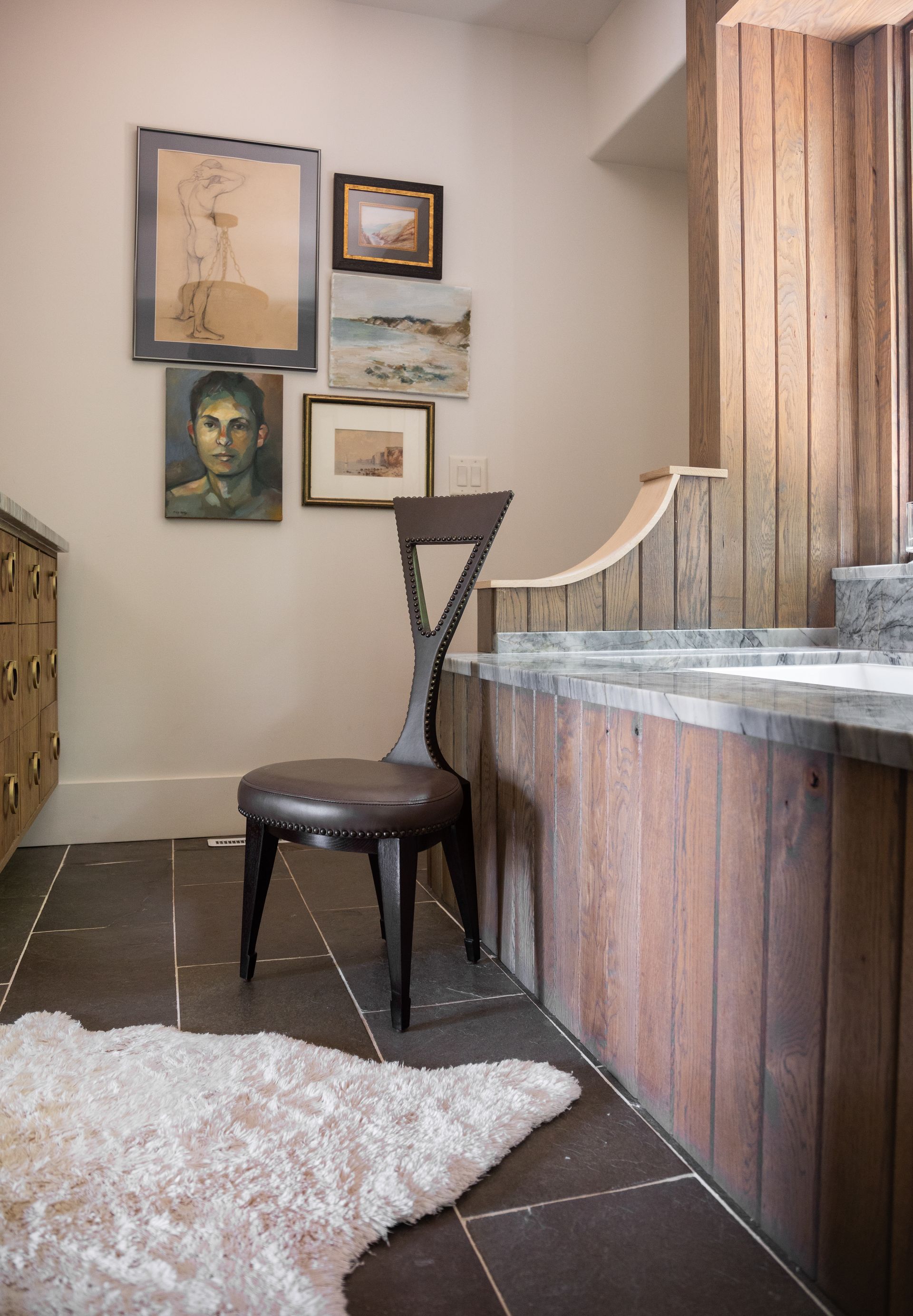 A Bathroom With A Chair And A Rug On The Floor