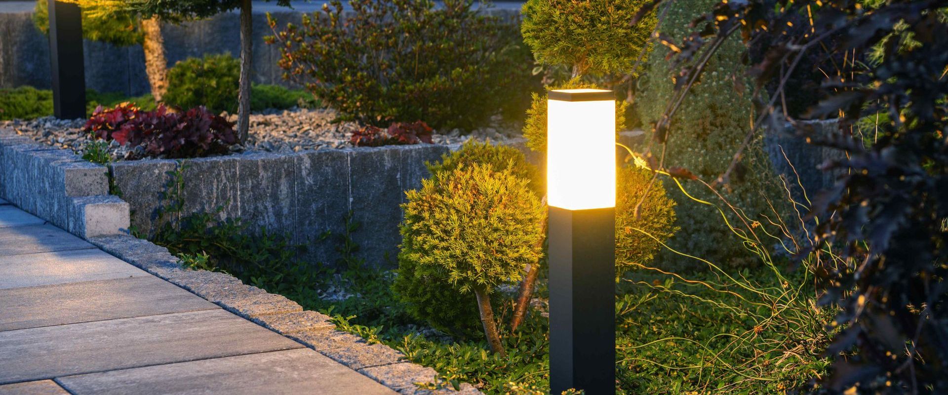 Lamps Along Pathway Through Garden