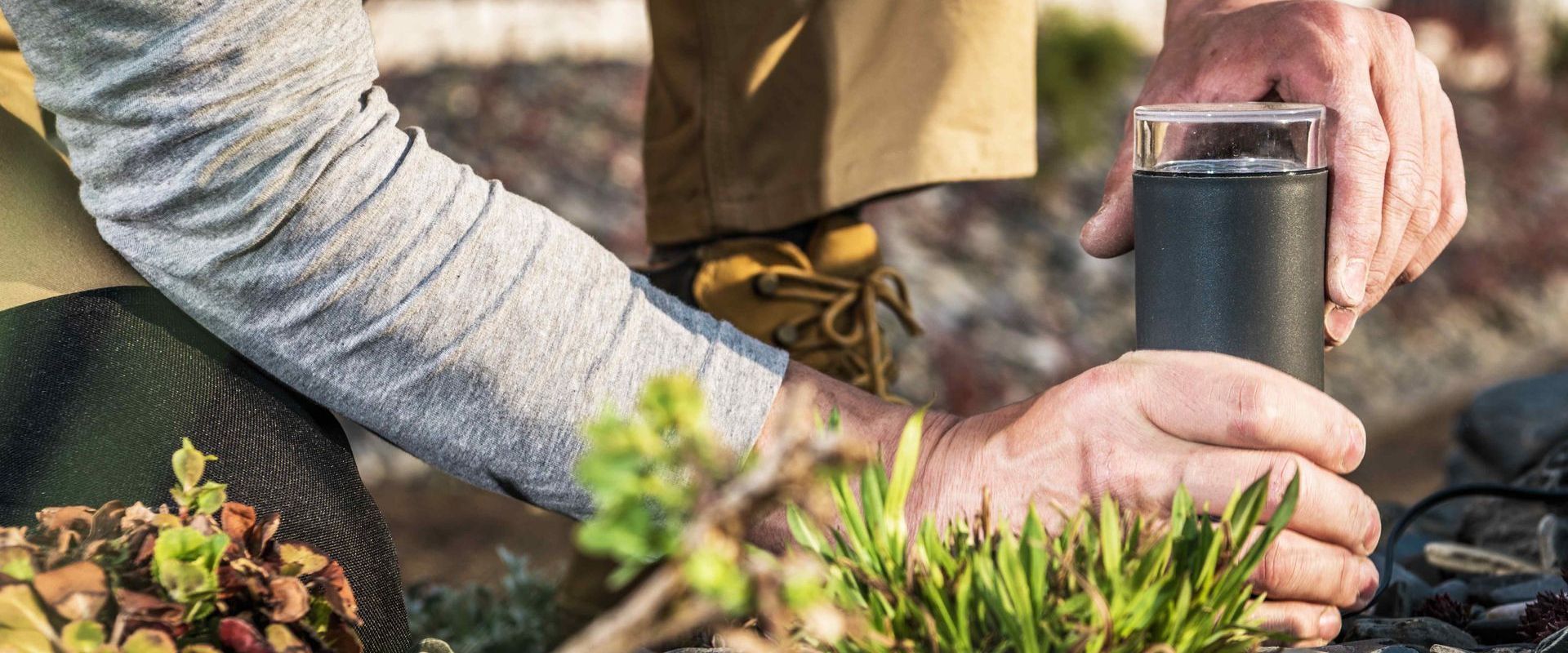 Landscaper Installing Lights In Garden