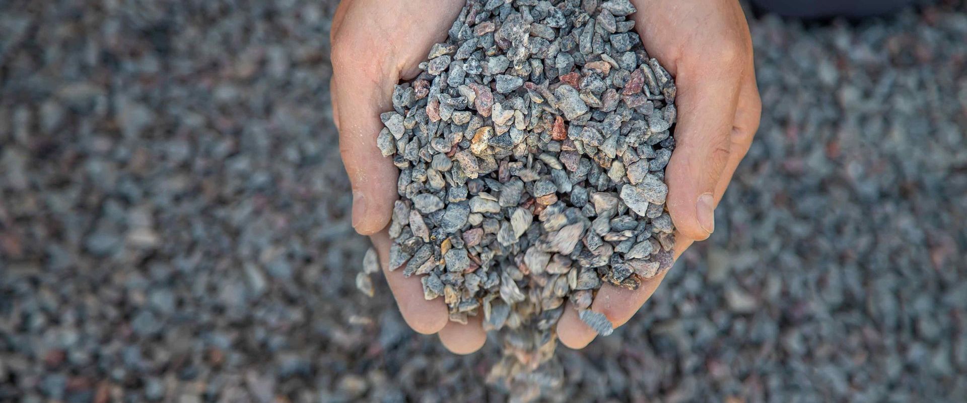 Man Holding Crushed Stone In His Hands