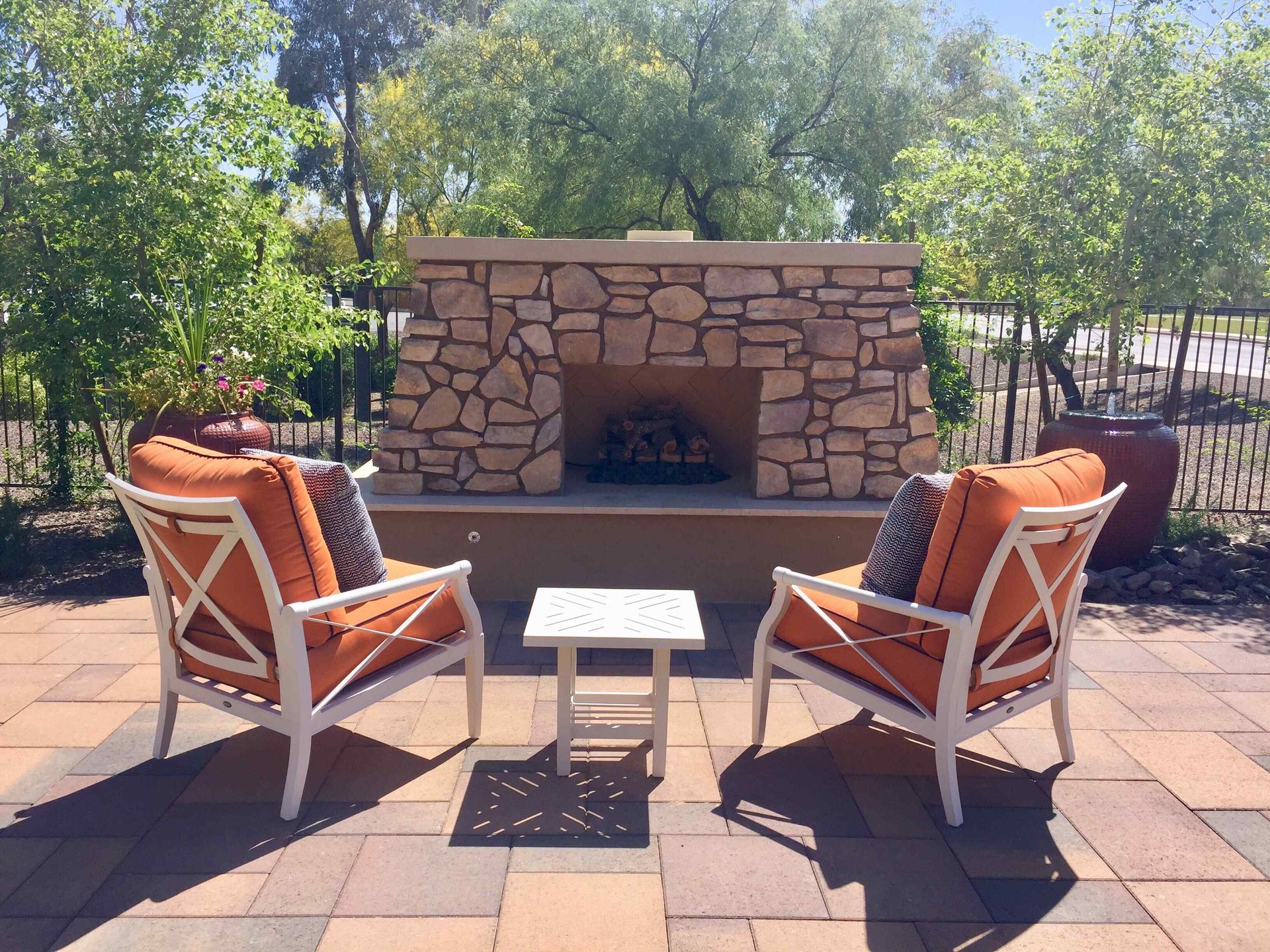 Large Affordable Outdoor Fireplace with Patio And Chairs Surrounded By Trees