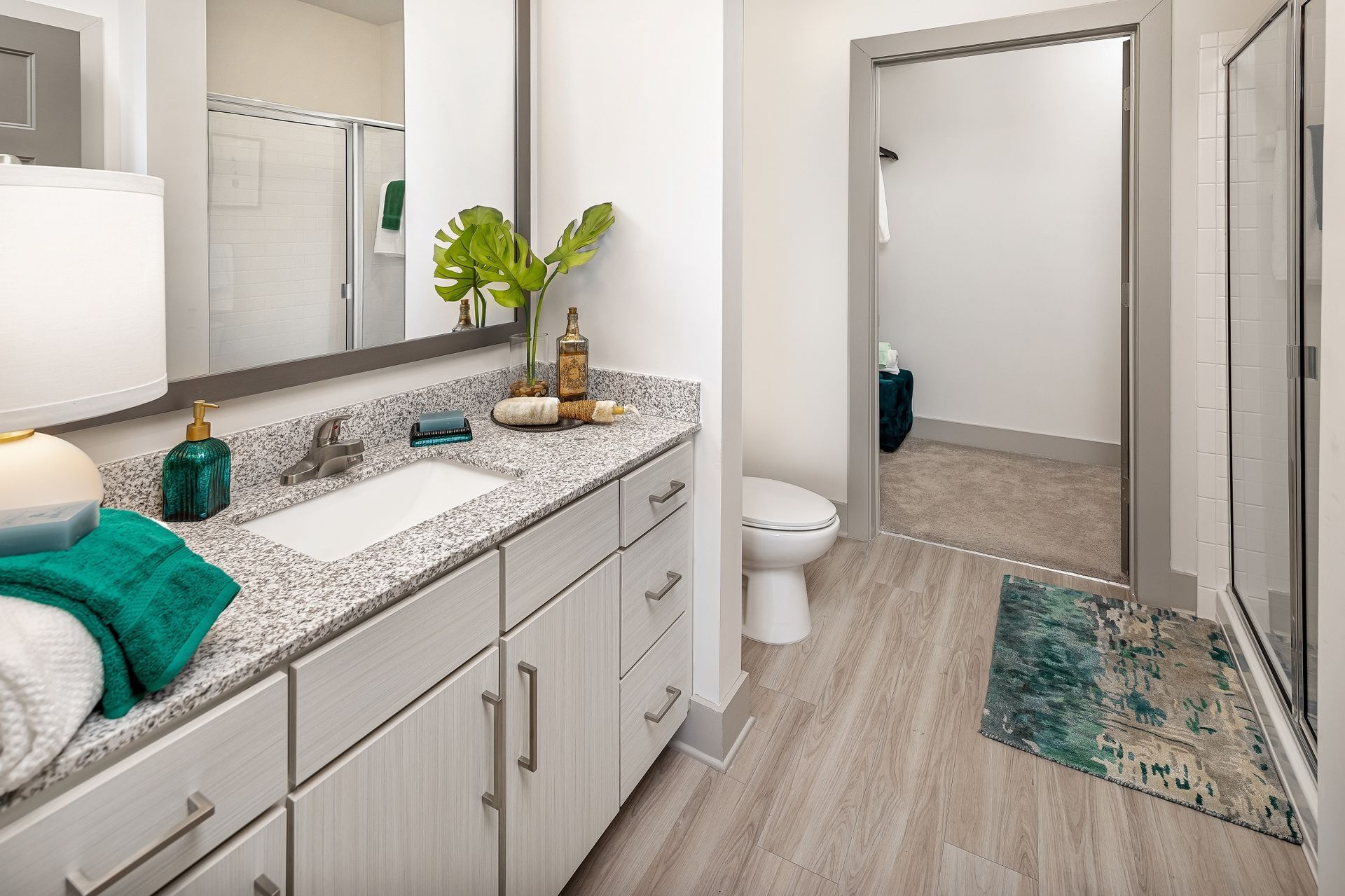 A bathroom with a sink , toilet , and mirror.