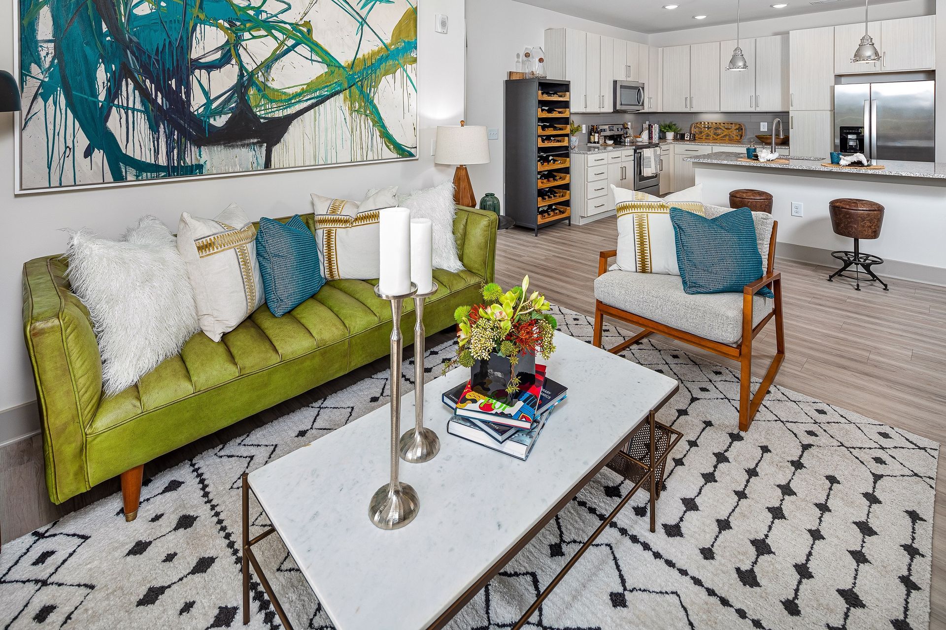A living room with a green couch and a white coffee table.