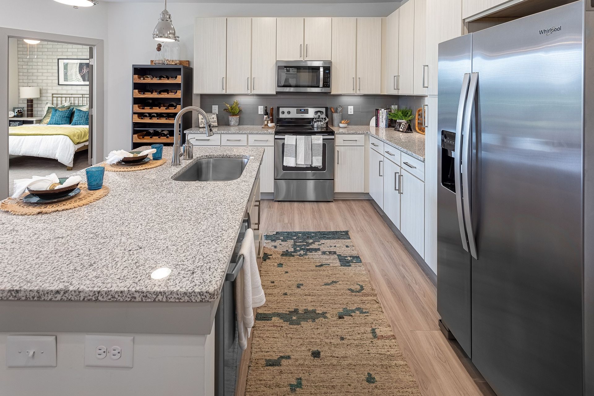 A kitchen with granite counter tops and stainless steel appliances.