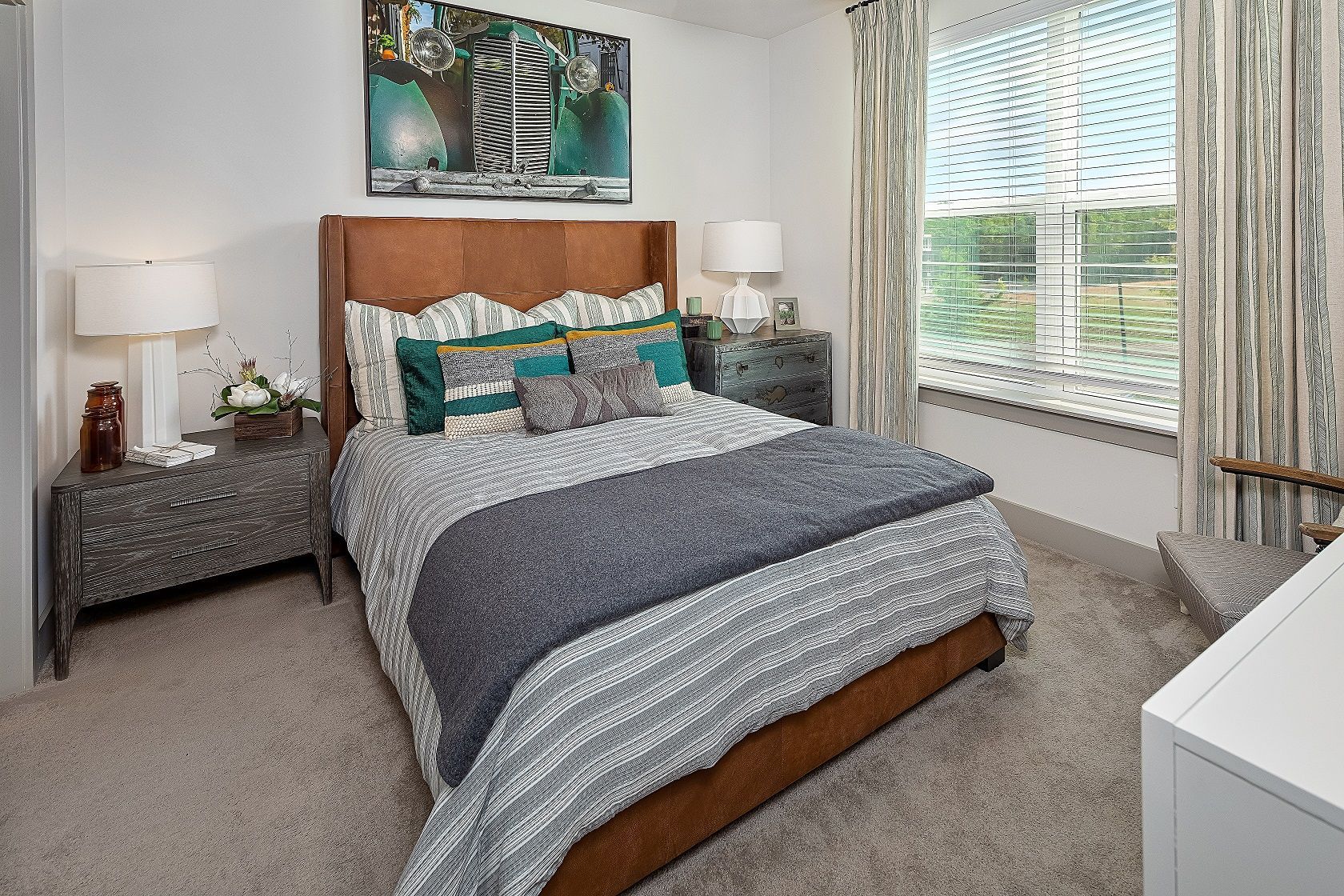 A bedroom with a large bed and a window.
