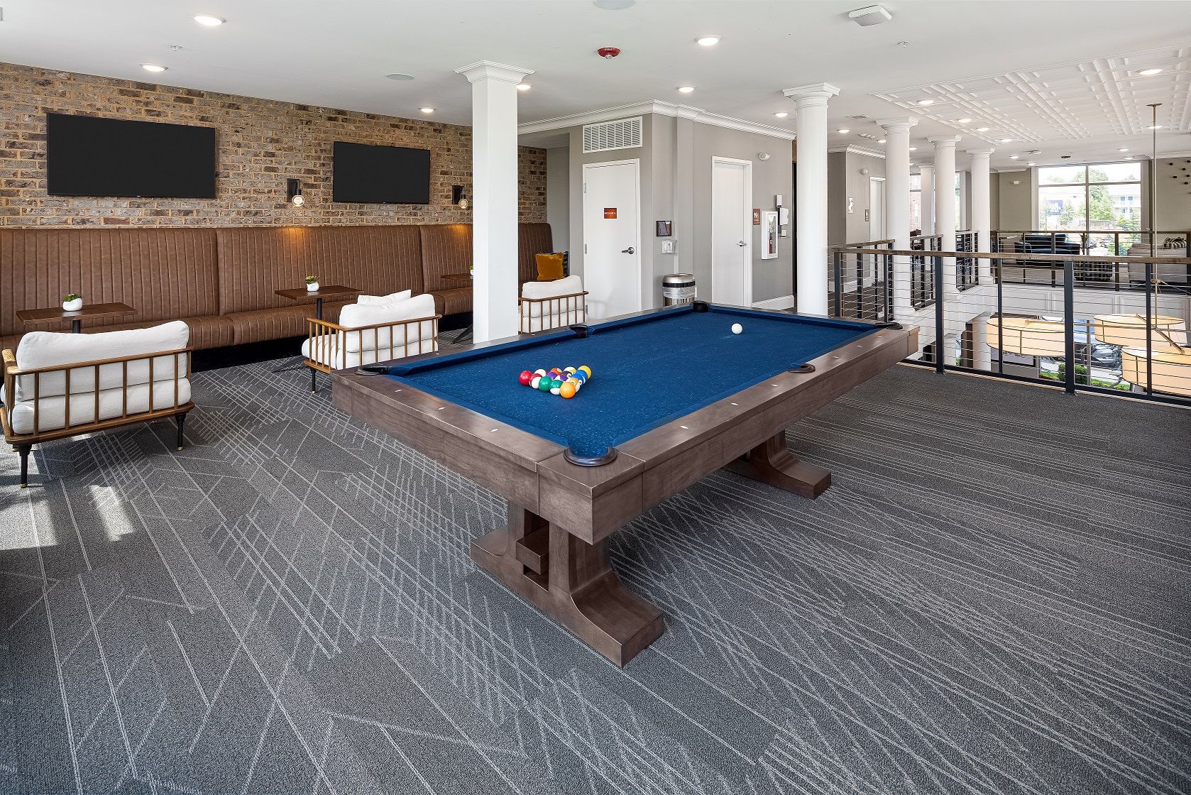 There is a pool table in the middle of the room.