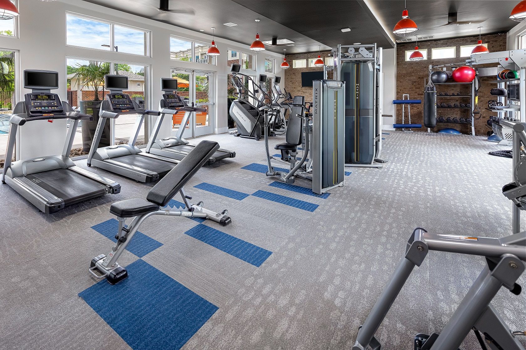 A large gym with a lot of treadmills and exercise equipment.