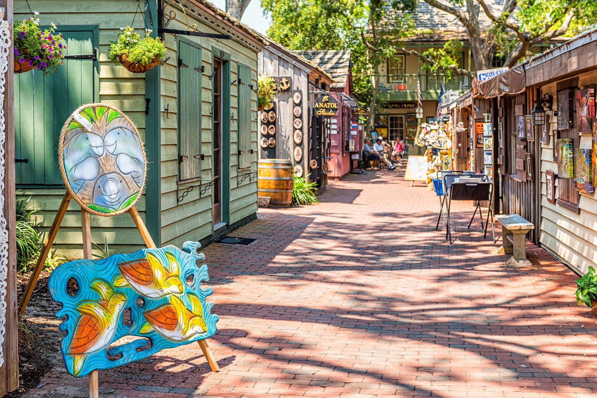 There is a painting on a stand in the middle of the street.