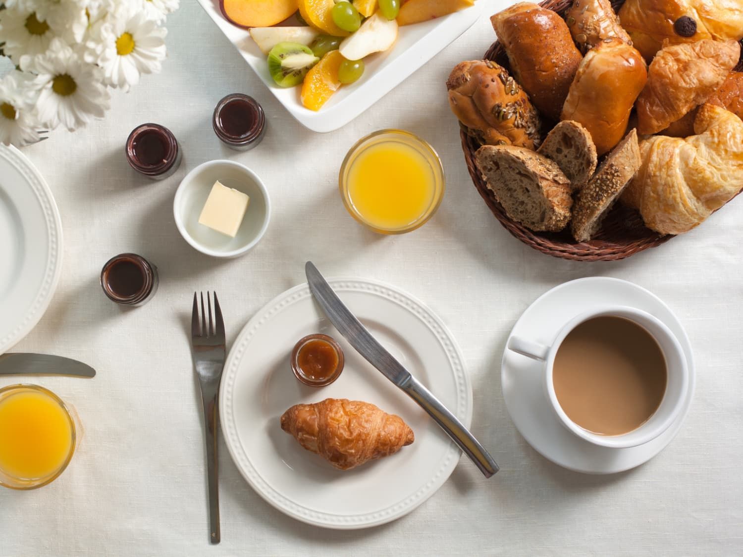 A table topped with plates of food and a cup of coffee