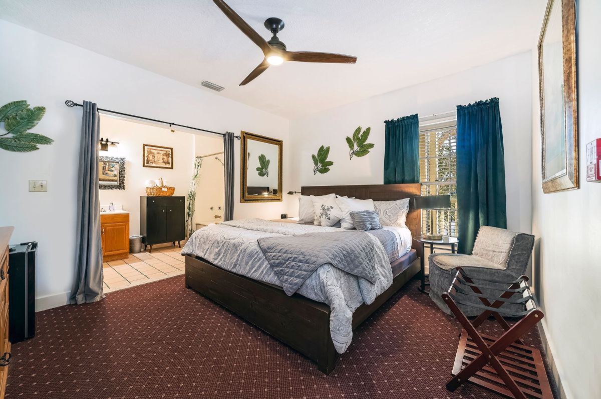 a bedroom with a large bed and a ceiling fan .