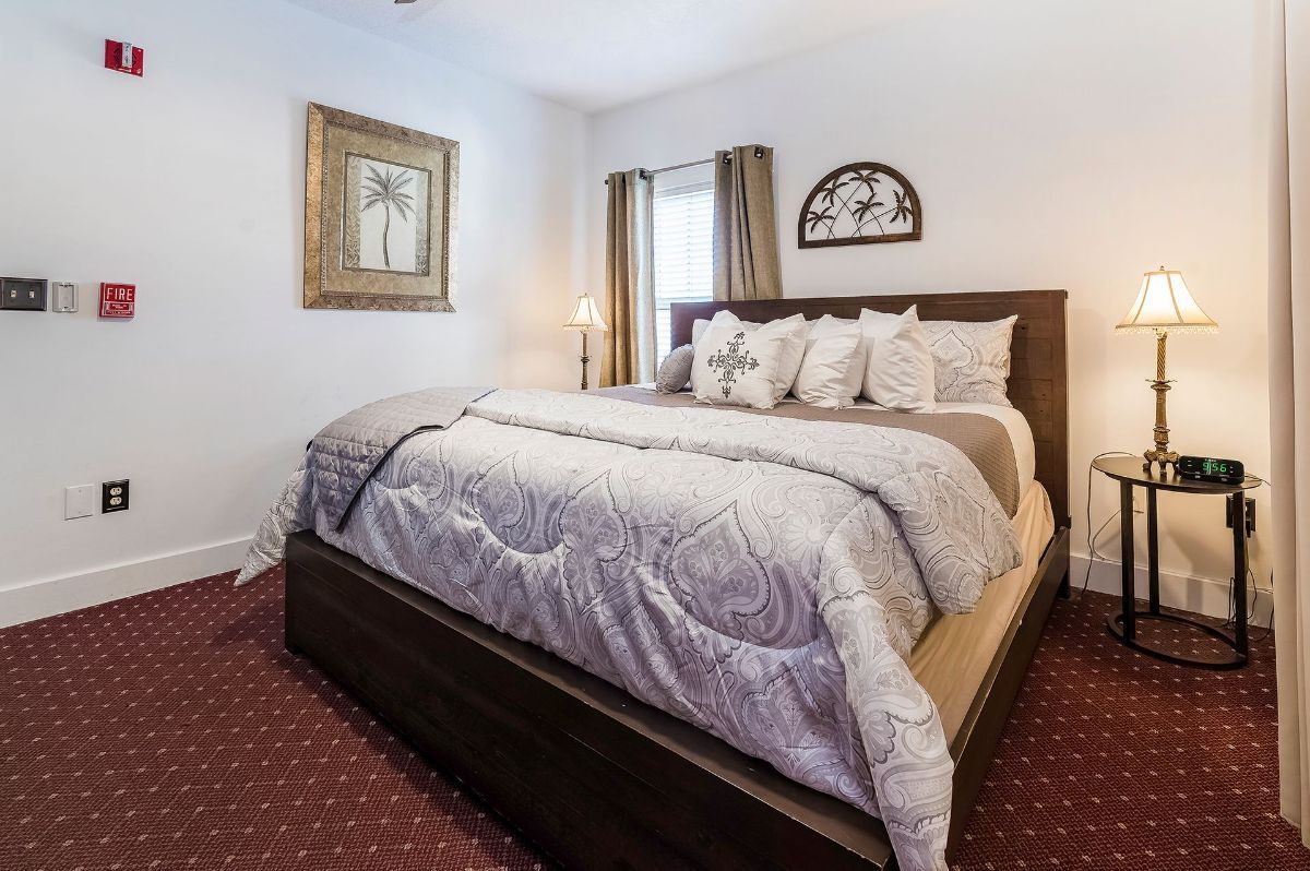 a bedroom with a king size bed and two lamps