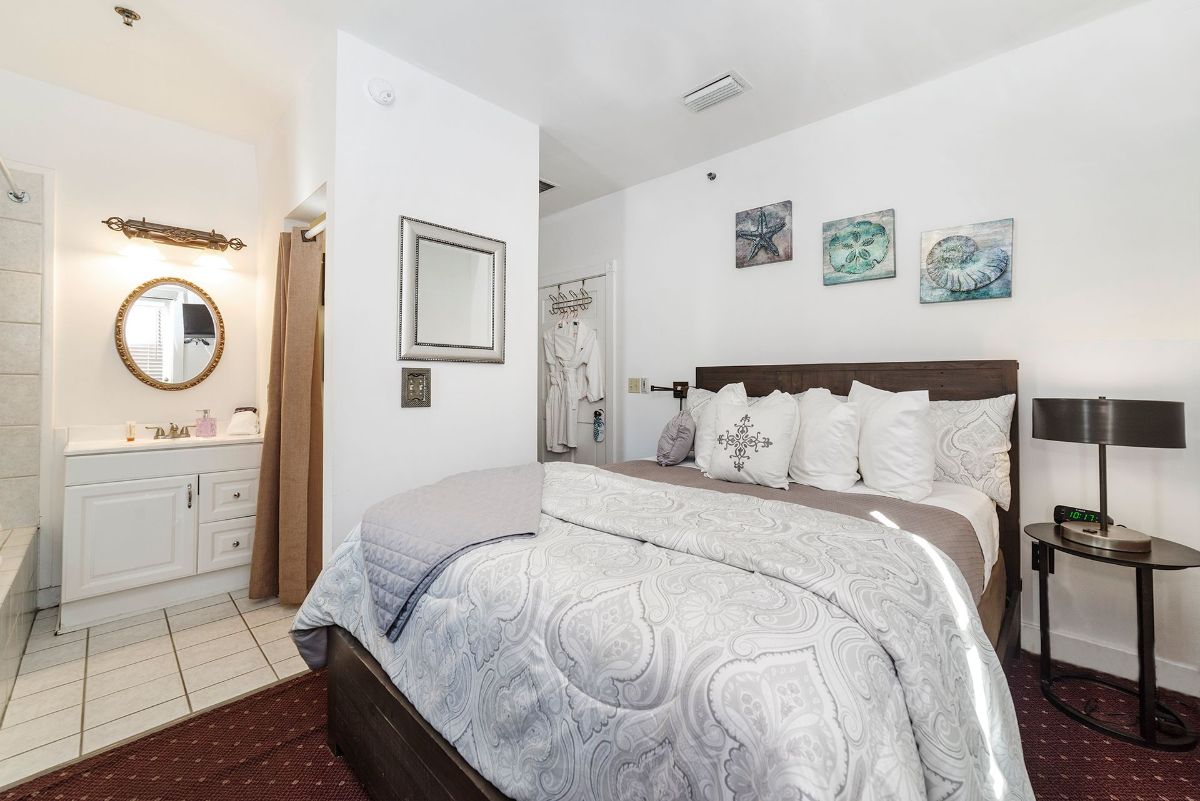 a bedroom with a king size bed and a bathroom .