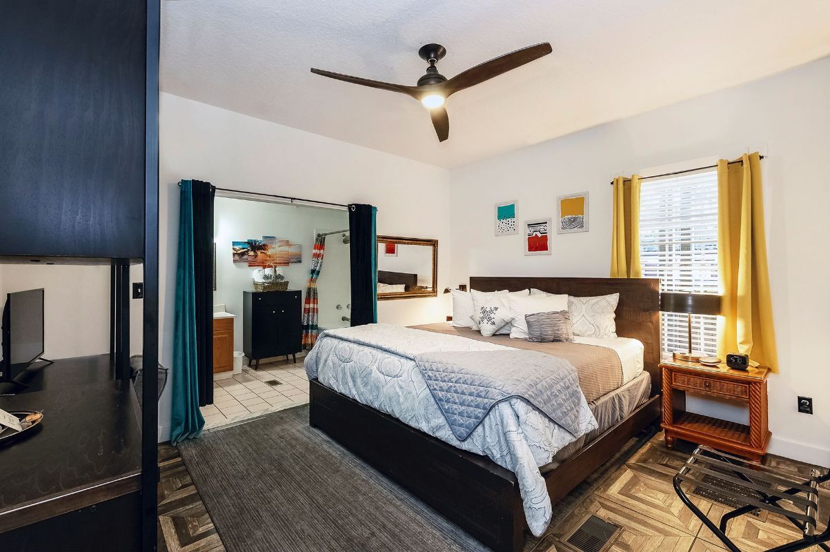 a bedroom with a king size bed and a ceiling fan .