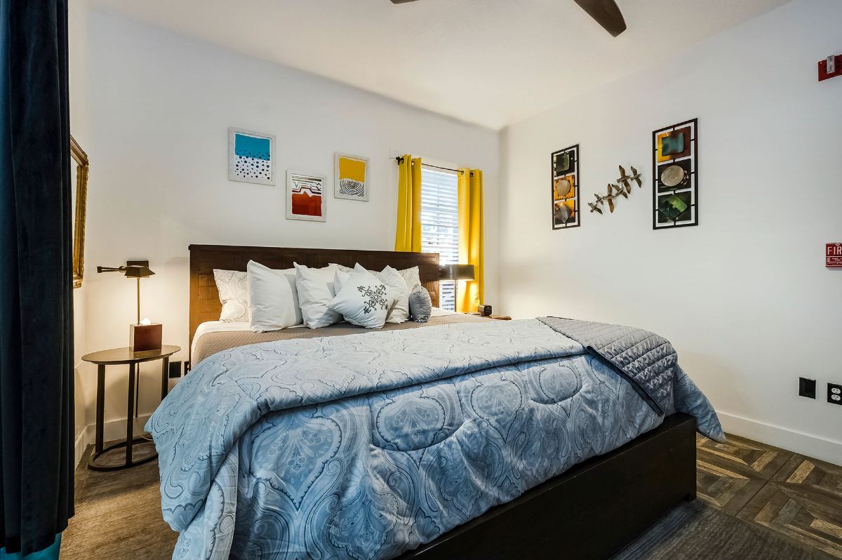 a bedroom with a king size bed and a ceiling fan .