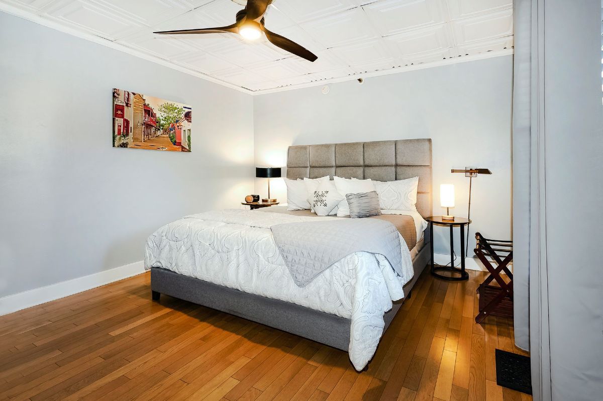 a bedroom with a bed and a ceiling fan .