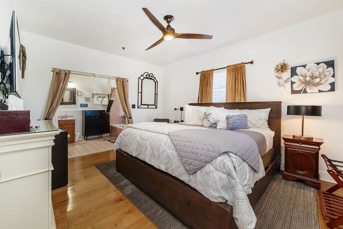 a bedroom with a large bed and a ceiling fan