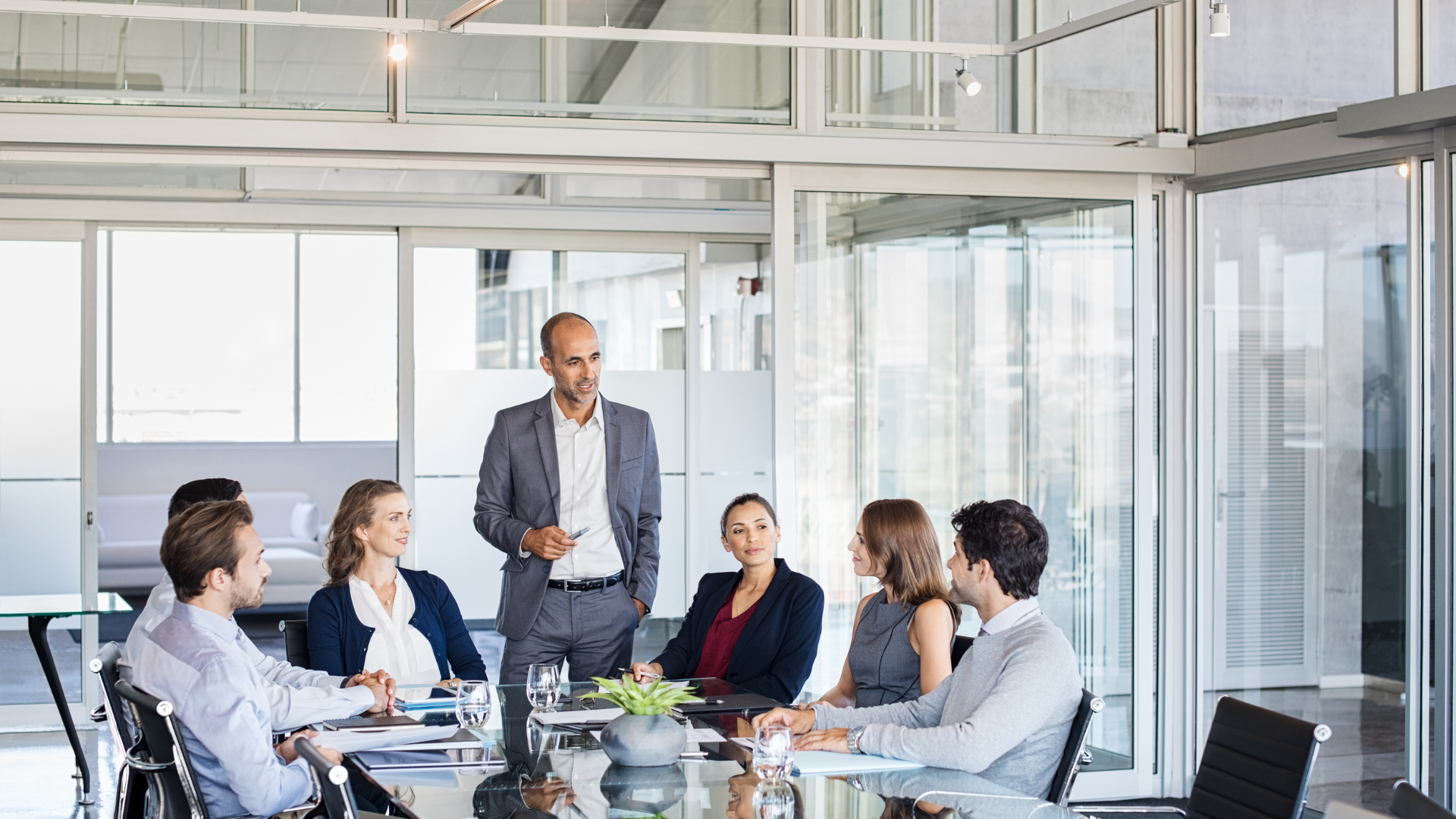 A group of business people are having a meeting in a conference room.