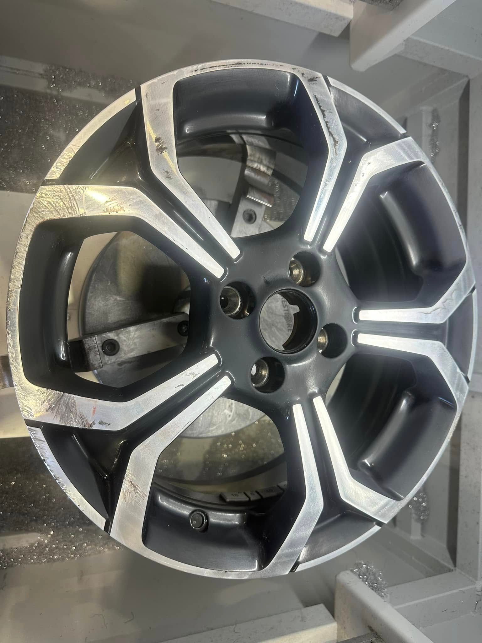 A close up of a car wheel on a shelf.